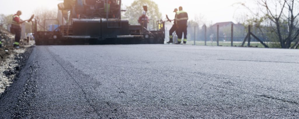 workers-placing-new-coating-asphalt-road