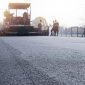 workers-placing-new-coating-asphalt-road